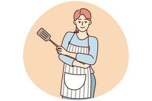 lächelnd Frau Hausfrau im Schürze steht mit Waffen gekreuzt mit Spatel zum Kochen. Vektor Bild