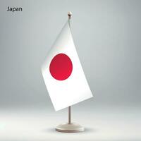 Flagge von Japan hängend auf ein Flagge Stand. vektor