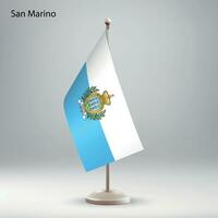flagga av san marino hängande på en flagga stå. vektor