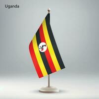 Flagge von Uganda hängend auf ein Flagge Stand. vektor