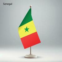 Flagge von Senegal hängend auf ein Flagge Stand. vektor