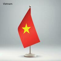 flagga av vietnam hängande på en flagga stå. vektor