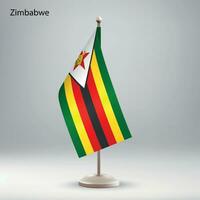 flagga av zimbabwe hängande på en flagga stå. vektor