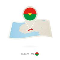 gefaltet Papier Karte von Burkina Faso mit Flagge Stift von Burkina faso. vektor
