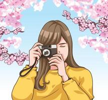 skön flicka innehav en kamera med blomma vektor