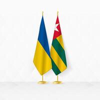 ukraina och Togo flaggor på flagga stå, illustration för diplomati och Övrig möte mellan ukraina och togo. vektor