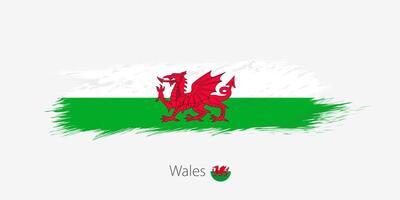 flagga av Wales, grunge abstrakt borsta stroke på grå bakgrund. vektor
