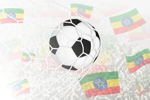 nationell fotboll team av etiopien gjorde mål mål. boll i mål netto, medan fotboll supportrar är vinka de etiopien flagga i de bakgrund. vektor