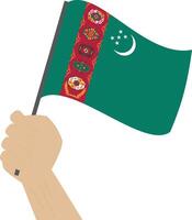 Hand halten und erziehen das National Flagge von Turkmenistan vektor