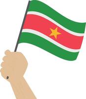 Hand halten und erziehen das National Flagge von suriname vektor