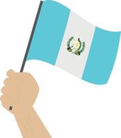 Hand halten und erziehen das National Flagge von Guatemala vektor