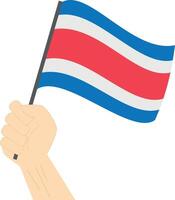 Hand halten und erziehen das National Flagge von Costa Rica vektor