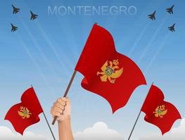 montenegrinska flaggor vajar under den blå himlen vektor