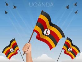 uganda-flaggen wehen unter dem blauen himmel vektor