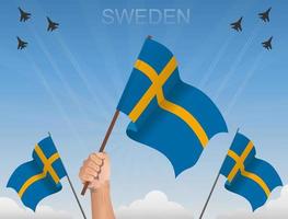 svenska flaggor vajar under den blå himlen