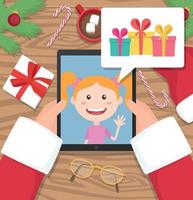 Der Weihnachtsmann hält Tablet und unterhält sich mit einem jungen Mädchen, das über Geschenke spricht, die er zu Weihnachten bekommen möchte vektor
