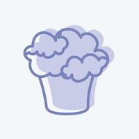 cupcake-ikonen i trendig tvåfärgad stil isolerad på mjuk blå bakgrund vektor