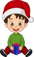 tecknad liten pojke som bär juldräkt som håller en presentv vektor
