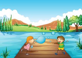 Ein junges Mädchen und ein Junge, die mit den Blasen spielen vektor