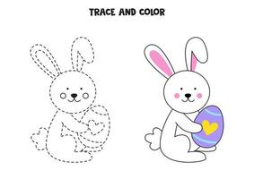 spåra och färga söt påskhare som håller ett ägg. arbetsblad för barn. vektor