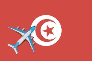 vektorillustration eines passagierflugzeugs, das über die tunesische flagge fliegt. Konzept von Tourismus und Reisen vektor