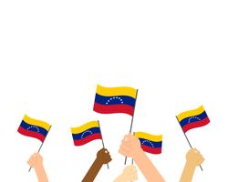 Vector Illustration von den Händen, die Venezuela-Flaggen halten, die auf weißem Hintergrund lokalisiert werden