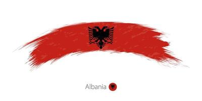 Albaniens flagga i rundad grunge penseldrag. vektor