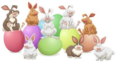 många kaniner som sitter på färgglada ägg vektor