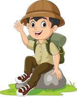 tecknad pojke scout sitta på rock viftande hand vektor