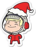 Fröhlicher Aufkleber-Cartoon eines Astronauten mit Weihnachtsmütze vektor