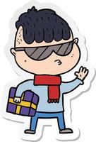klistermärke av en tecknad pojke som bär solglasögon som bär julklapp vektor