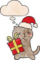 niedliche karikaturkatze, die weihnachtsgeschenk und gedankenblase im schmutzbeschaffenheitsmusterstil trägt vektor