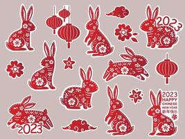 satz chinesisches neujahr 2023 der kaninchenaufkleber mit roter papierschnittkunst. der hase - chinesisches tierkreissymbol vektor