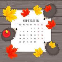 kalender för september månad, ett pappersark, höstlöv och igelkottar på bakgrunden av träskivor, vektorillustration vektor