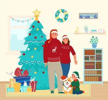 glückliche familie in weihnachtsoutfits mit süßem corgi-hund zu hause