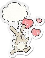 tecknad kanin i kärlek och tankebubbla som ett bedrövat slitet klistermärke vektor