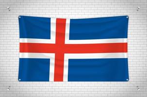 Island-Flagge hängt an der Ziegelwand. 3D-Zeichnung. Flagge an der Wand befestigt. Ordentliches Zeichnen in Gruppen auf separaten Ebenen für eine einfache Bearbeitung. vektor
