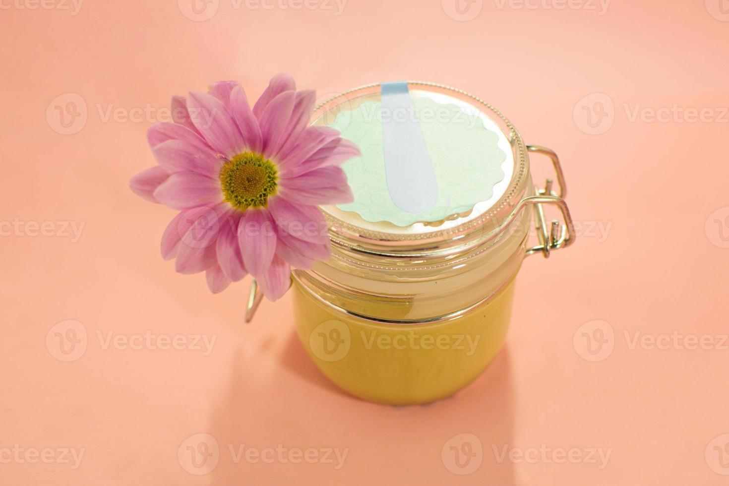 pâte à sucre pour épilation. shugaring. épilation. produits de beauté. miel en pot avec fleur. photo