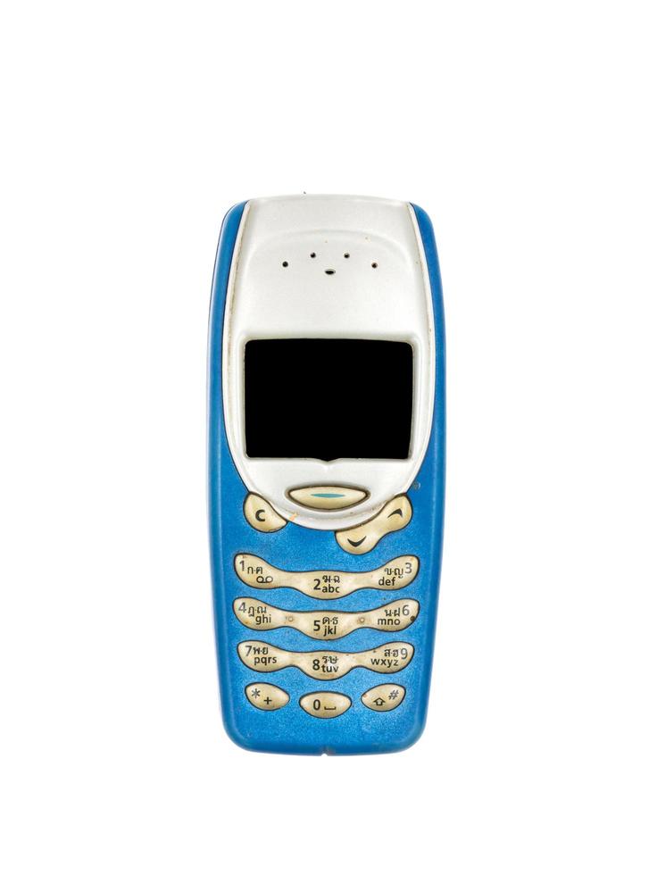 Vieux téléphone portable sur fond blanc photo
