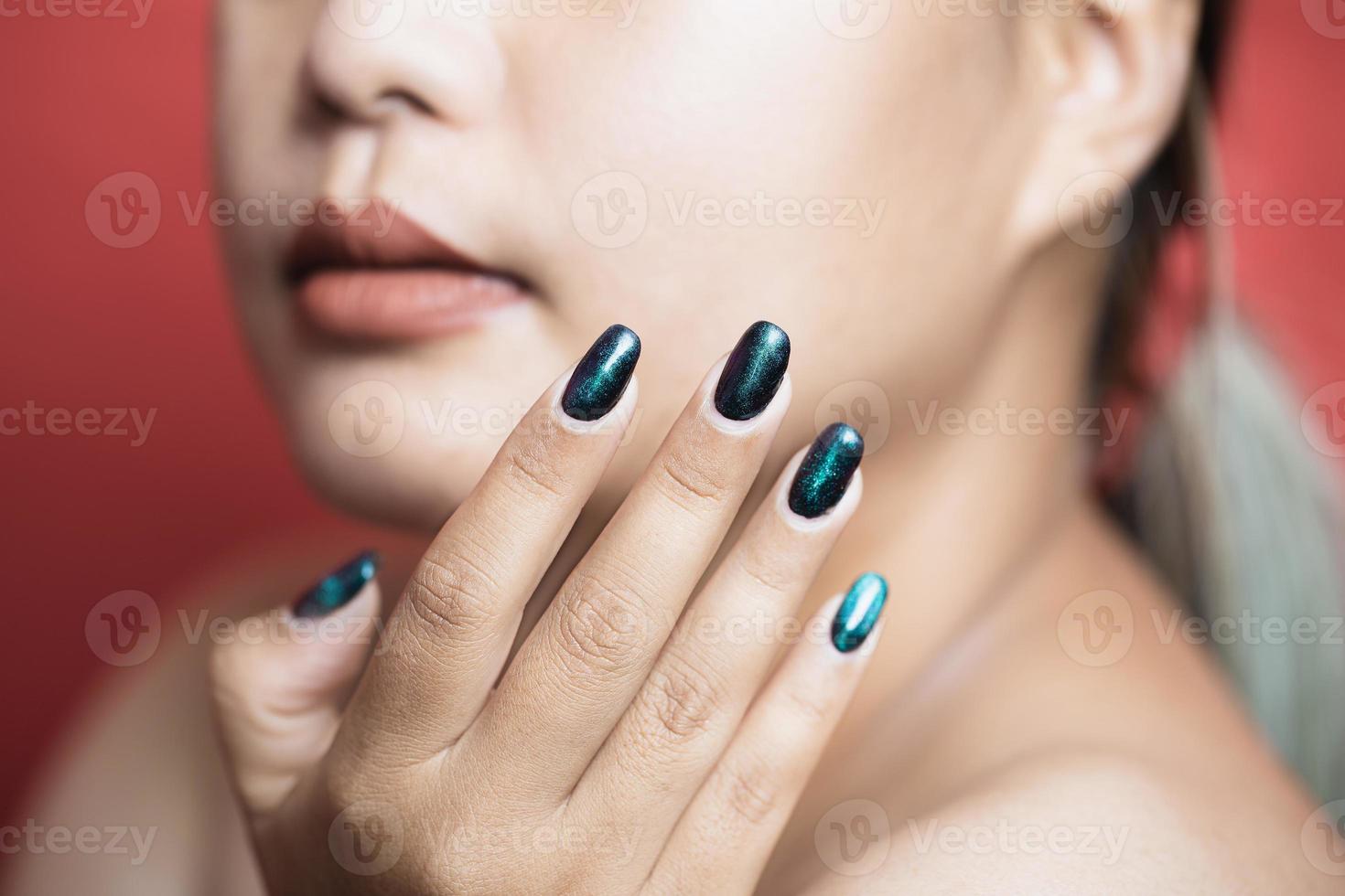 fille modèle de beauté avec des ongles de manucure verts. maquillage de mode femme et soin des mains cosmétiques. soins de santé. salon de beauté. peau propre et lisse, lèvres nues. main près du visage photo