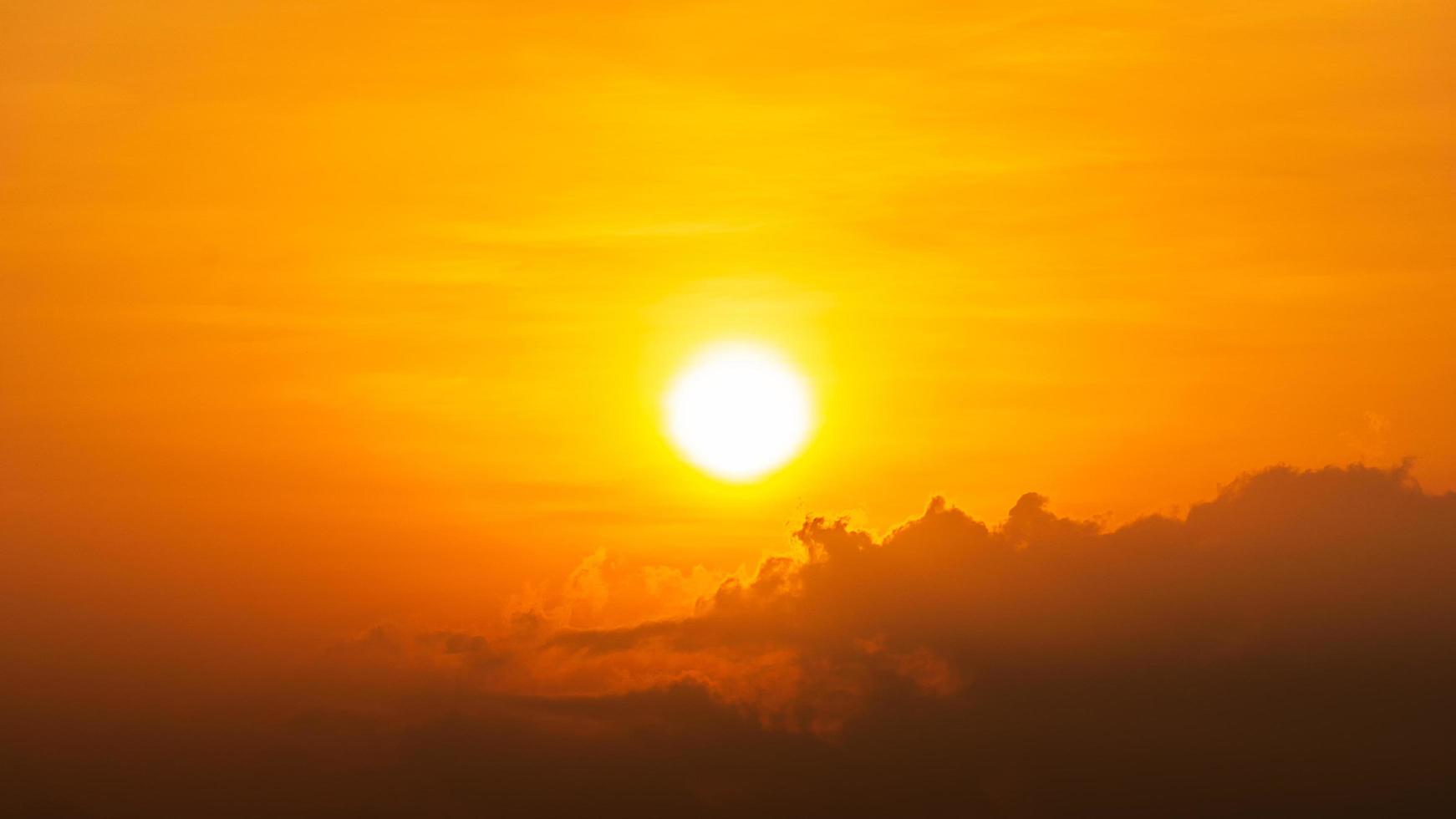 soleil éclatant et nuage sur fond naturel de ciel orange photo