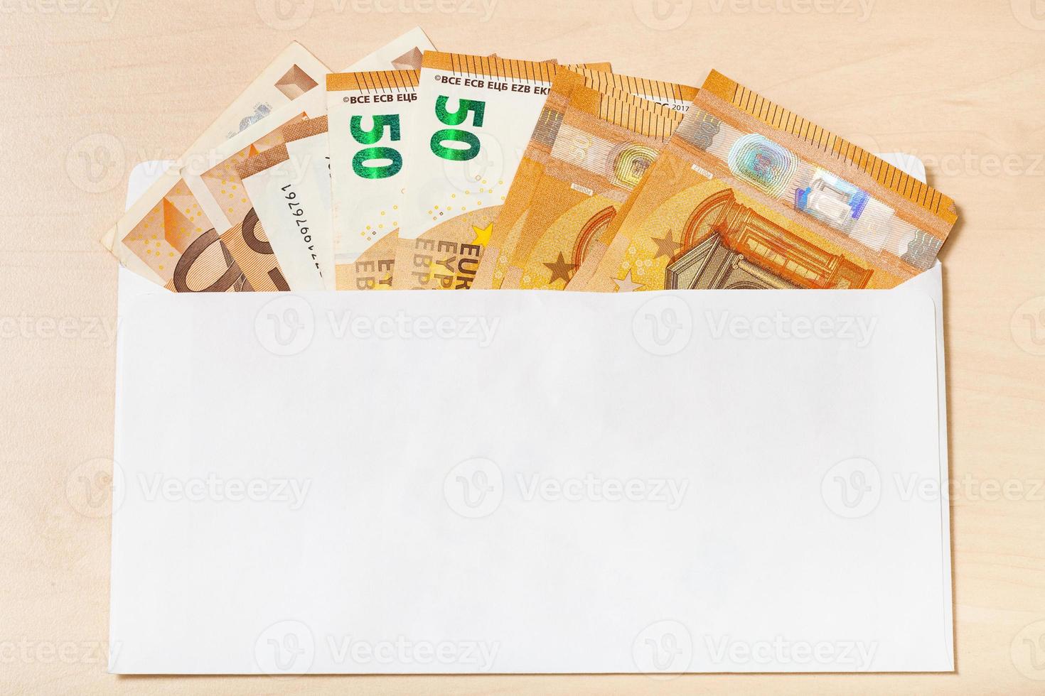 ventilateur de plusieurs billets de cinquante euros dans une enveloppe ouverte photo