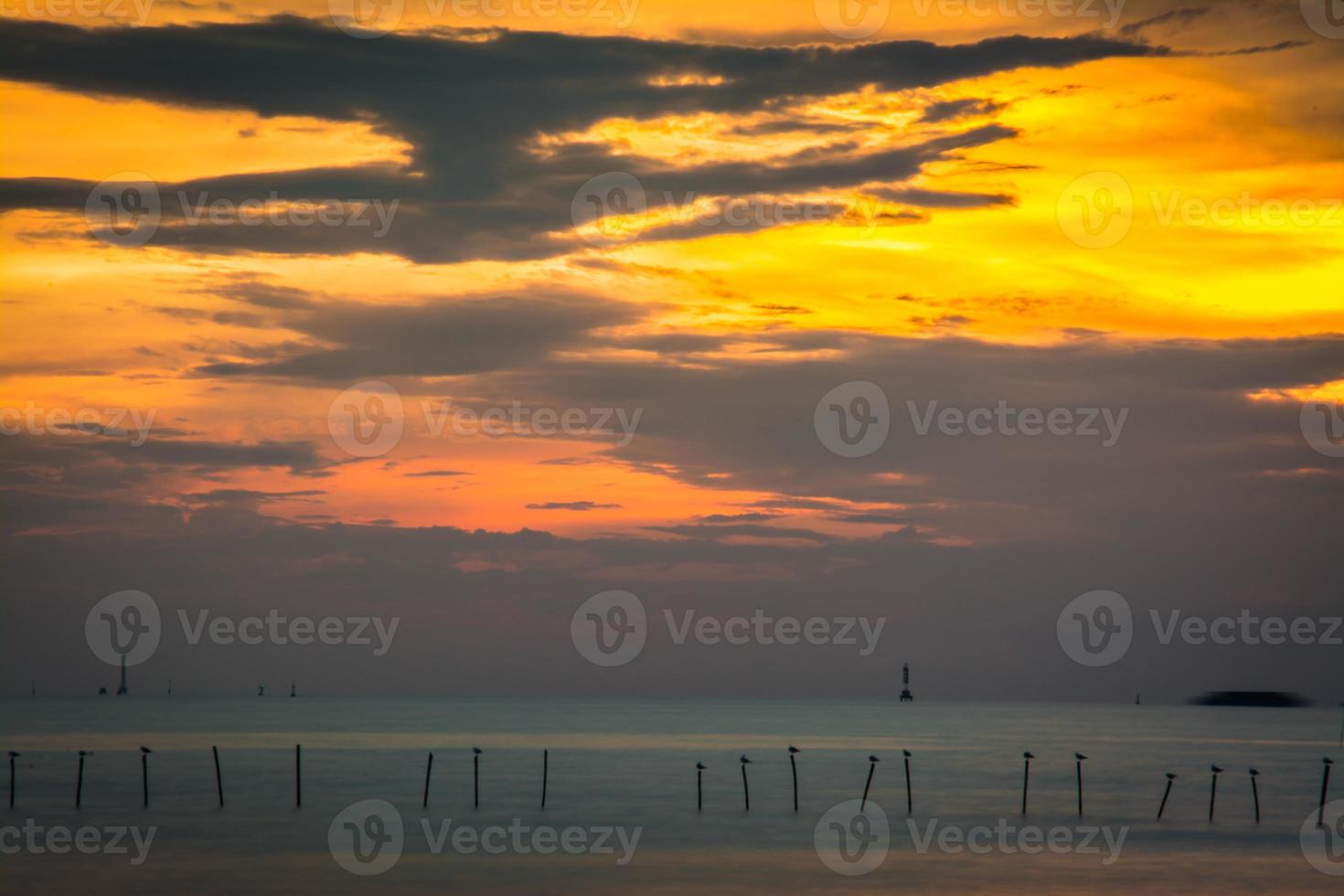 ciel coucher de soleil avec des nuages coucher de soleil spectaculaires sur la mer. beau lever de soleil sur l'océan photo