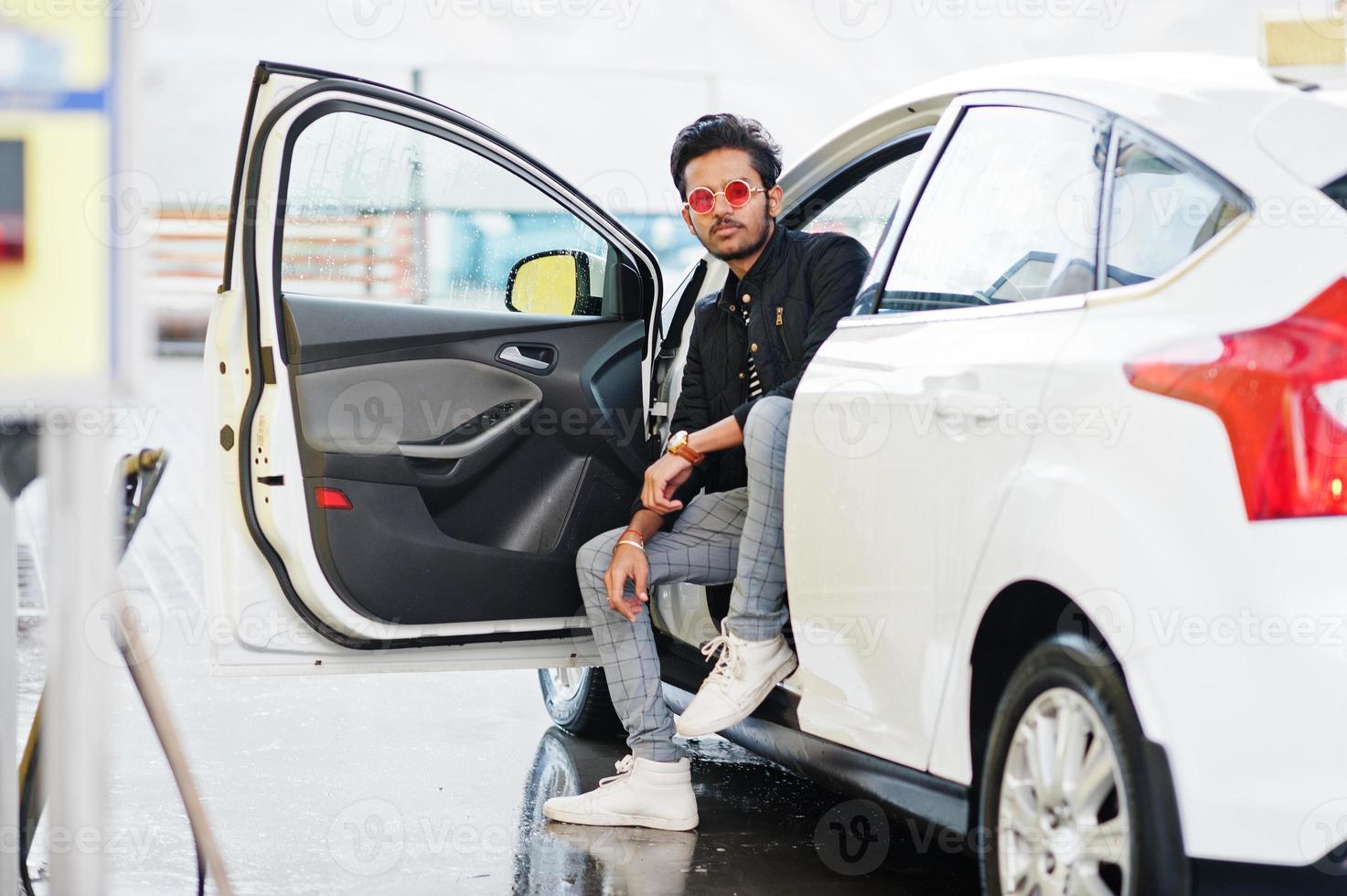 homme sud-asiatique ou homme indien lavant son transport blanc sur le lave-auto. photo