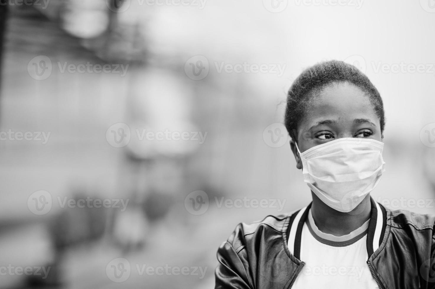 une fille africaine au parc portant des masques médicaux protège contre les infections et les maladies quarantaine du virus coronavirus. photo