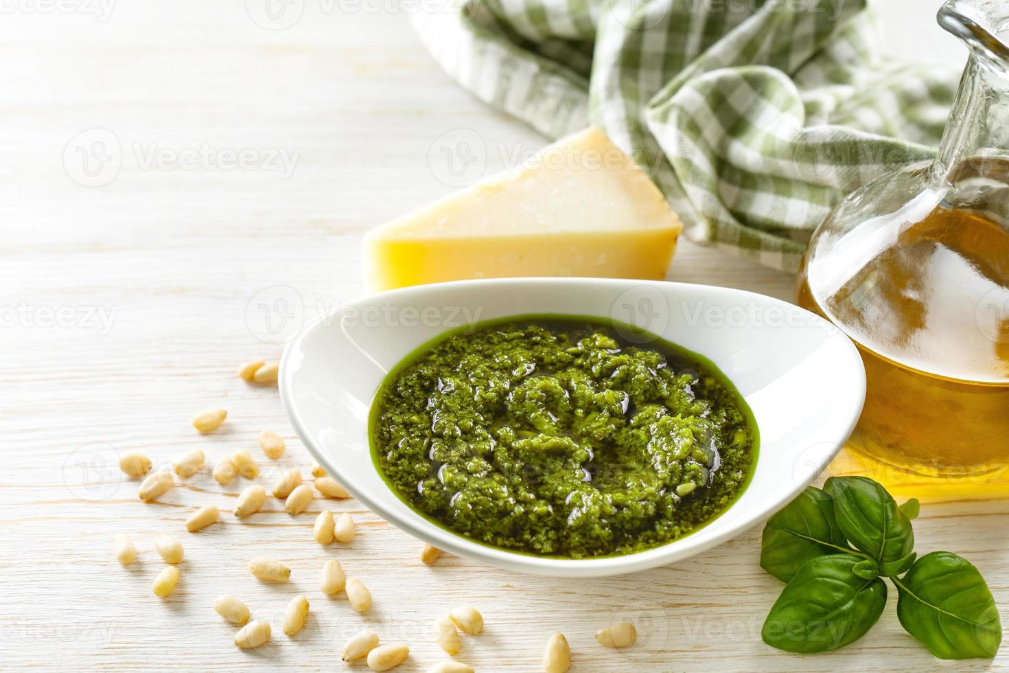 Sauce pesto maison avec des ingrédients alimentaires sur fond de bois blanc photo