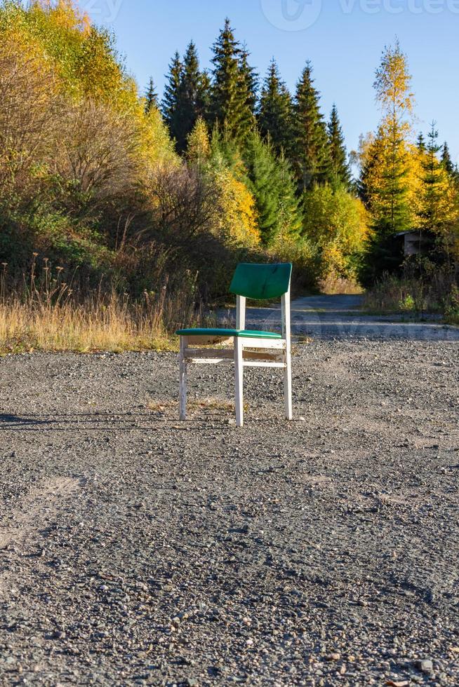 Chaise en bois blanc unique à l'extérieur sur du gravier photo