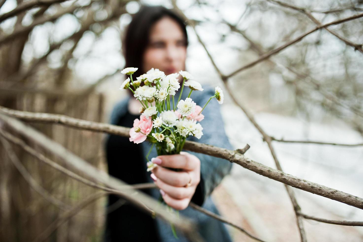 portrait de jeune fille brune en robe noire au bois de printemps. photo