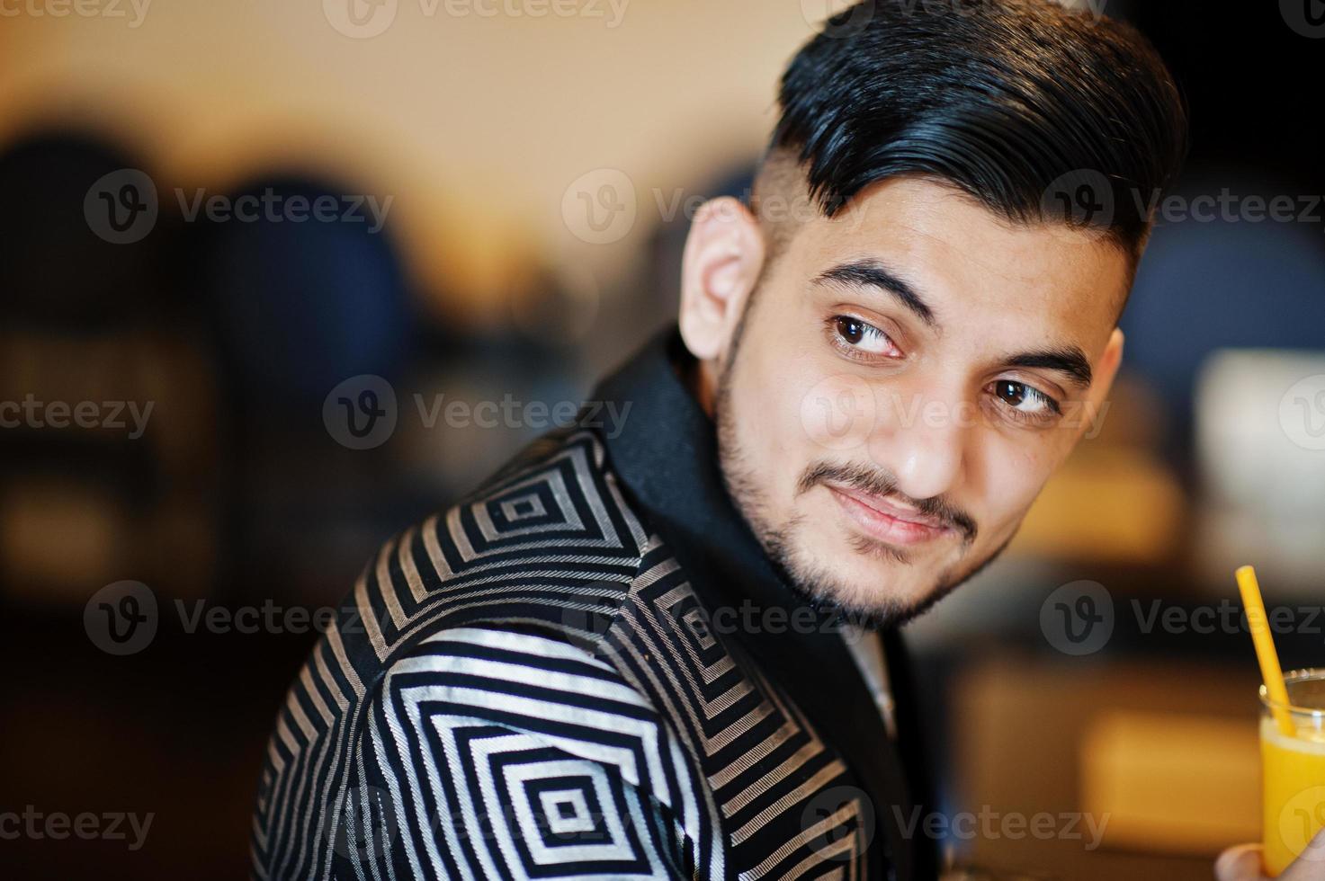 portrait en gros plan d'un jeune homme d'affaires indien beau en costume de soirée et cravate au restaurant. photo