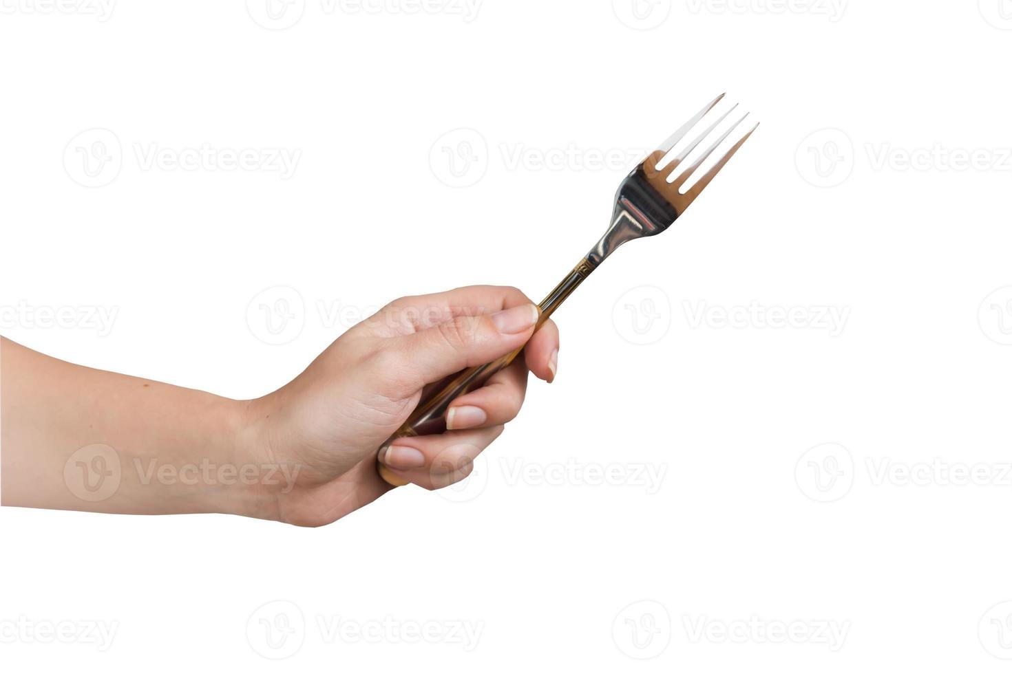 main de femme tenant une fourchette isolée sur fond blanc. geste de manger. photo